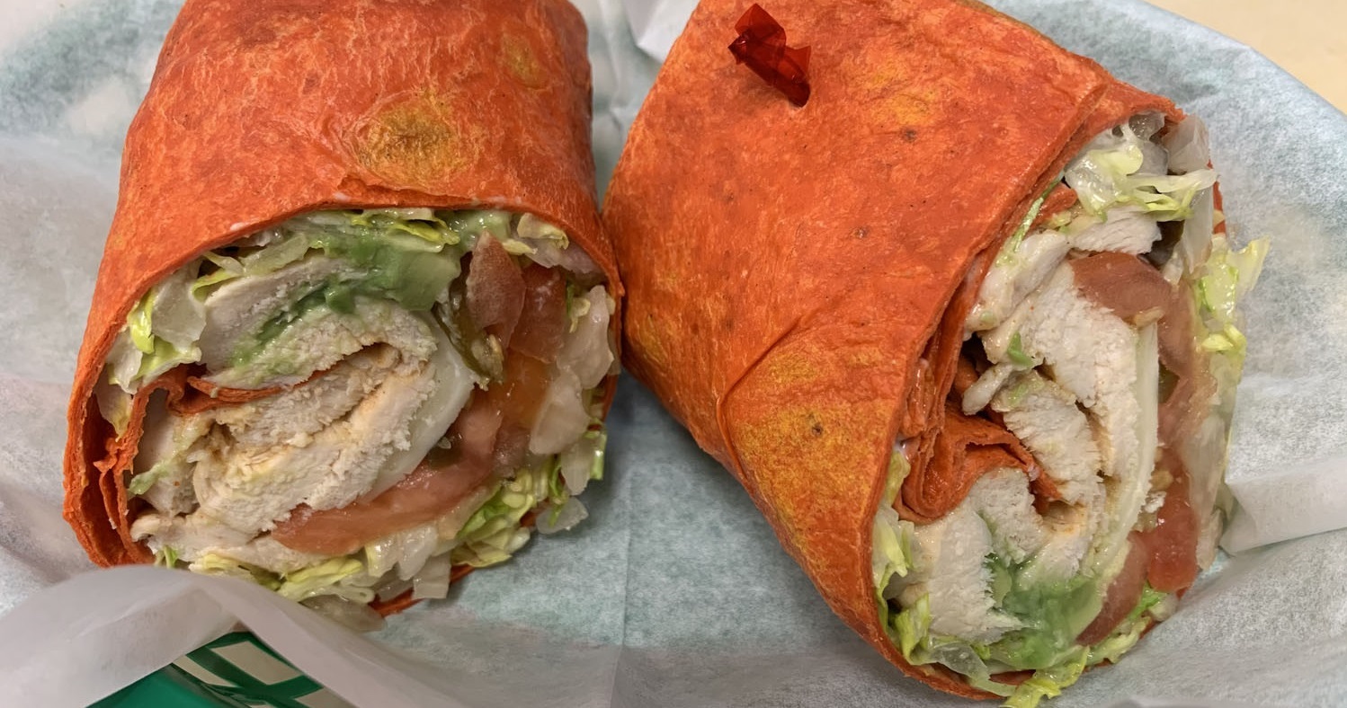 My Friend's Place Deli & Catering Chicken Wrap. Photo of a chicken wrap cut in half.